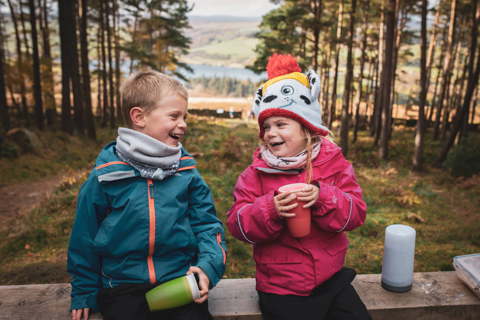 Children laughing together in the great outdoors, candid documentary family photography