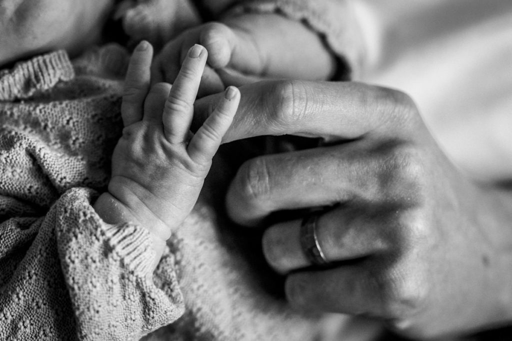 Tiny fingers holding onto Daddy