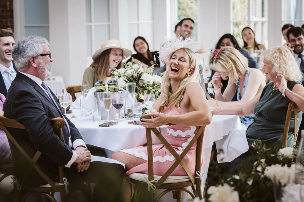 Documentary wedding photo of guests reacting during the speeches in Yorkshire