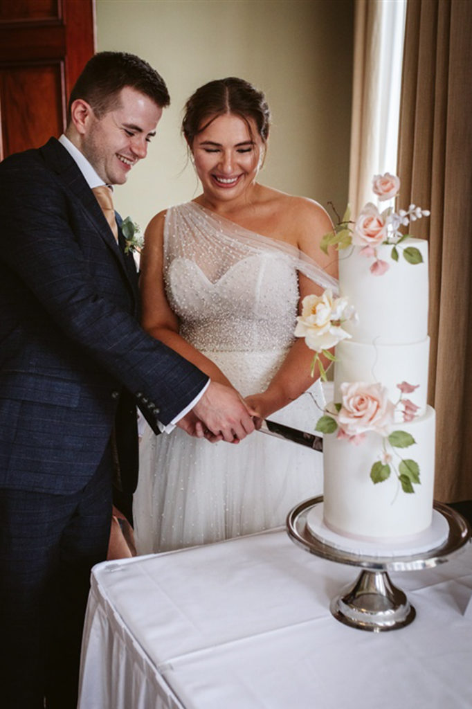 The Bride and Groom cut the cake