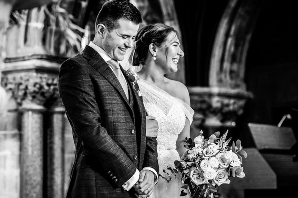 Wedding ceremony in the chapel at Rudding Park with guests watching on