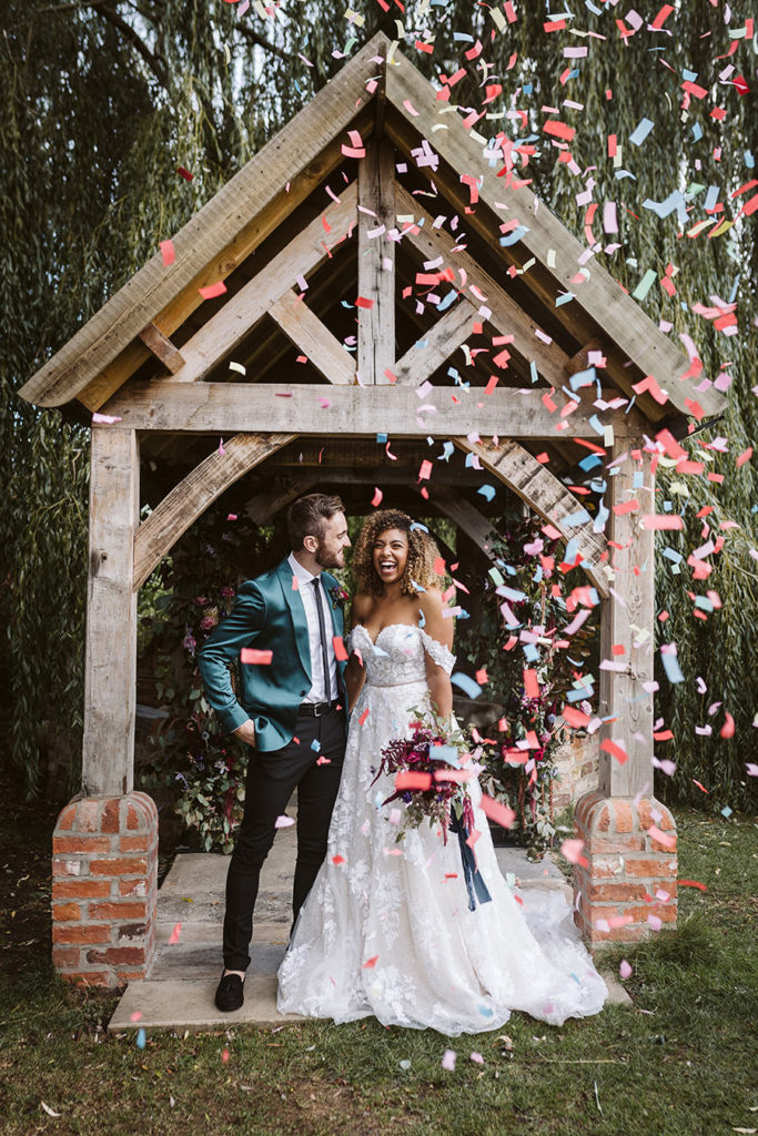 Autumn wedding confetti moment with warm seasonal tones