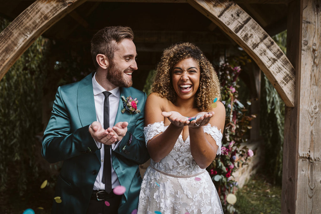 Bride and groom in bold autumn wedding styling at tipi venue