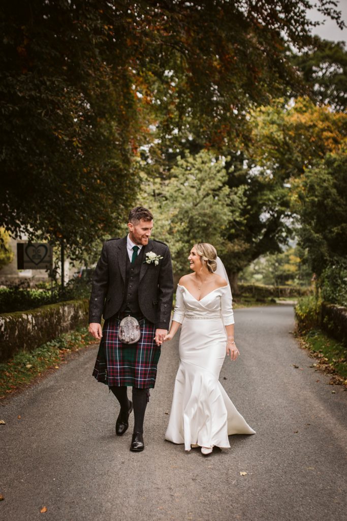 Couple walking through autumn colours at Yorke Arms