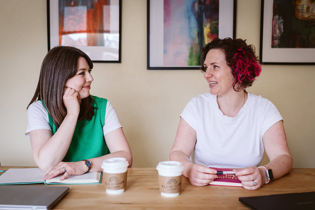 Business owners using notebooks during branding photoshoot