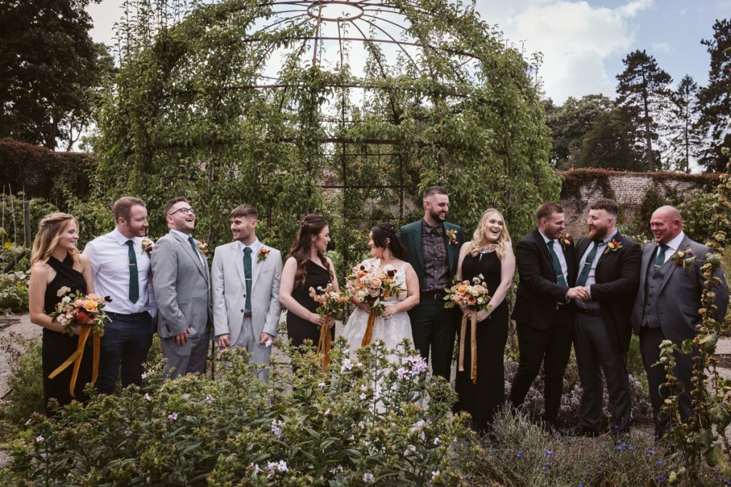 Bridal party group shot in the Walled Garden of the Fig House, Middleton Lodge