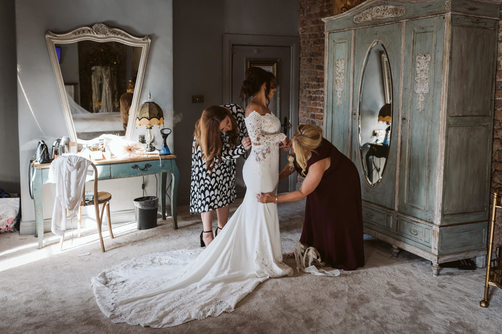 Bride in her Pronovias dress from Dotty Bridal during prep at Le Petit Chateau