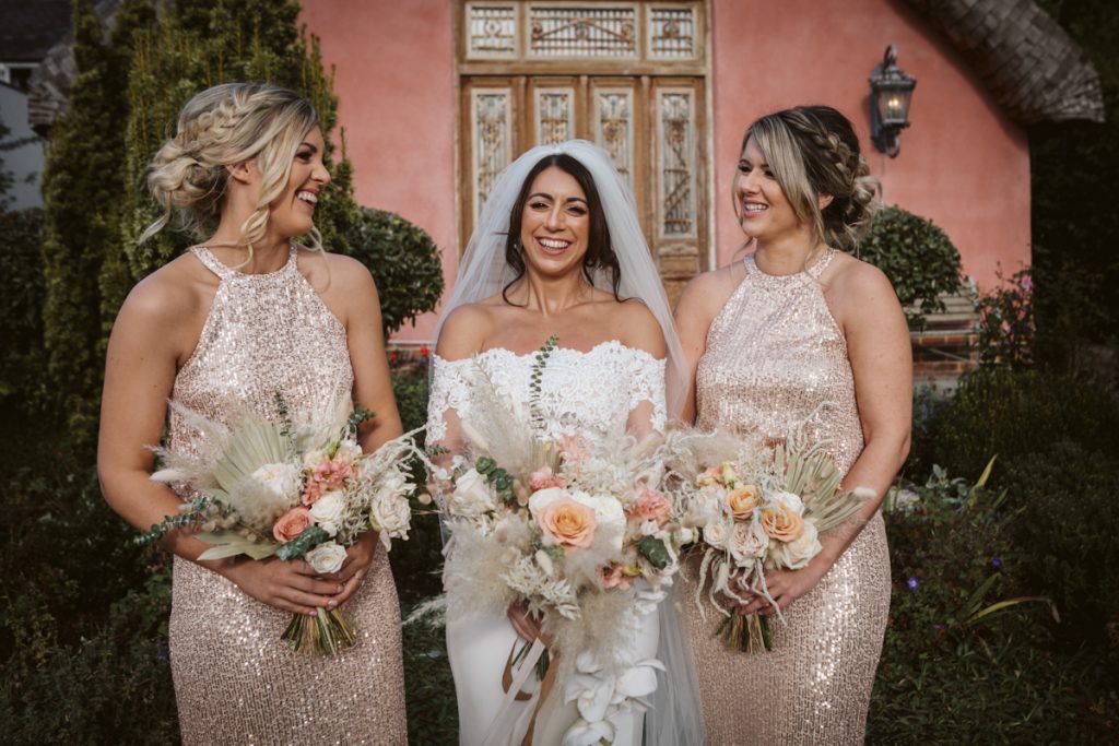 Family and Group shots with the stunning pink exterior of Le Petit Chateau weddings as the backdrop