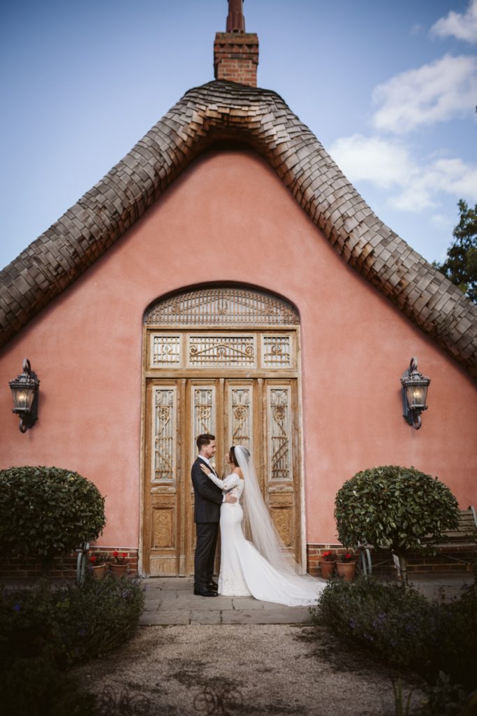 Couple portraits by the classy pink exterior of Le Petit Chateau in Otterburn, Northumberland