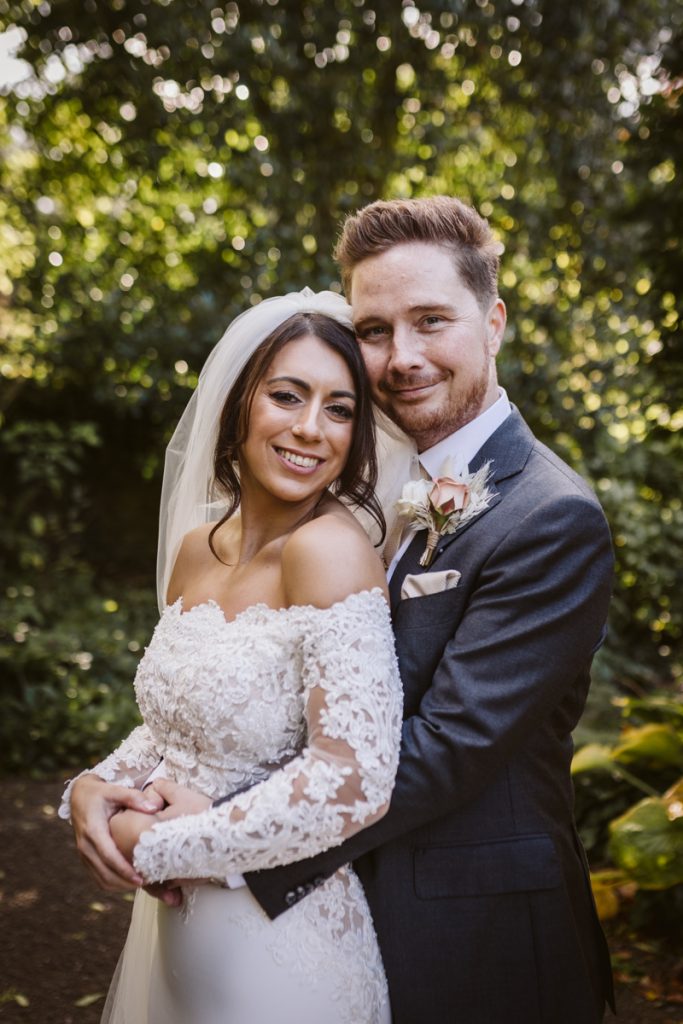 Relaxed bride and groom portrait in the gardens at Le Petit Chateau
