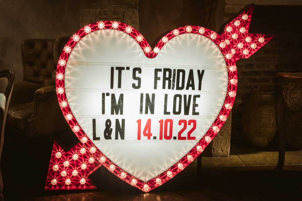 Custome neon sign saying it's friday I'm in love. Le Petit Chateau weddings.