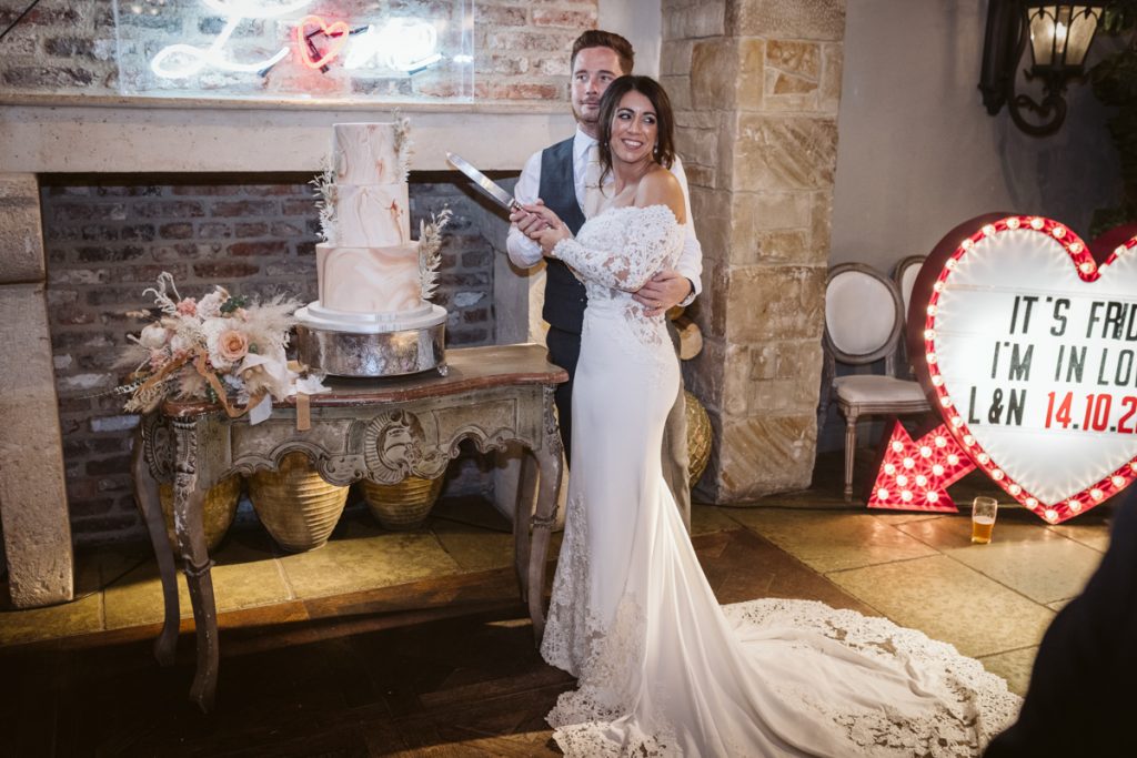 The bride and groom cutting their cake at Le Petit Chateau 