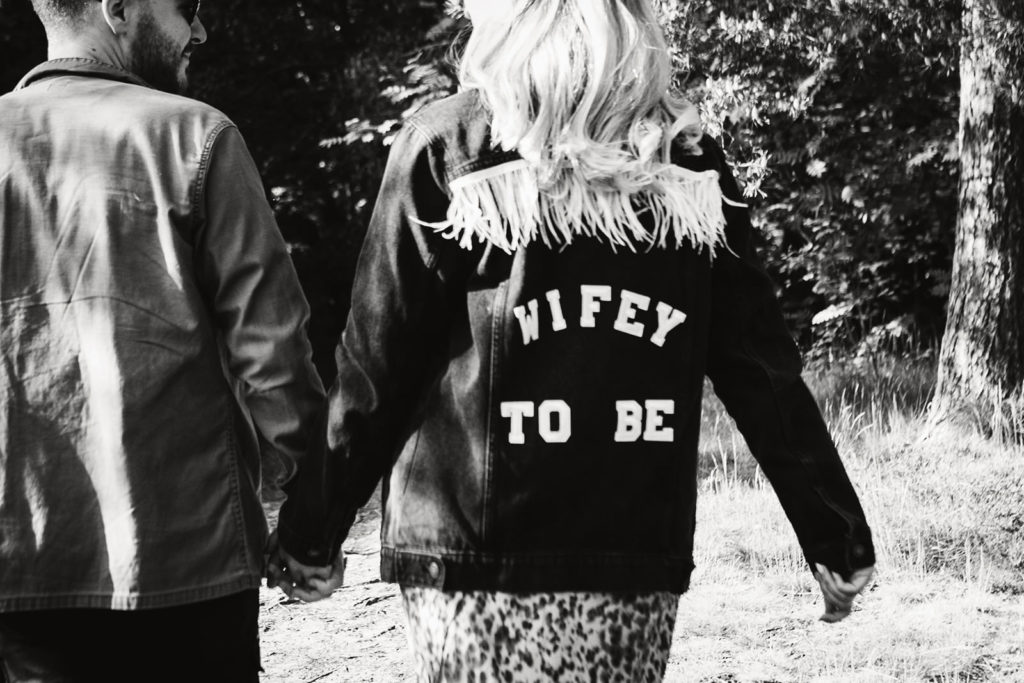 A bride to be wearing a "wifey to be" jacket on her pre-wedding photoshoot