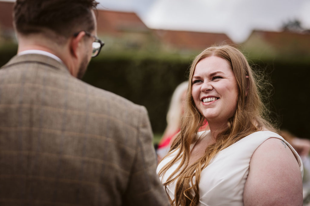 A candid mid ceremony moment between Bride & Groom