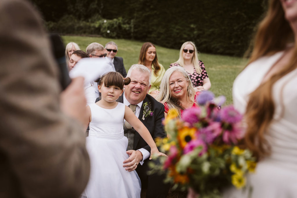 Proud family members look on as the Bride and Groom exchange their vows