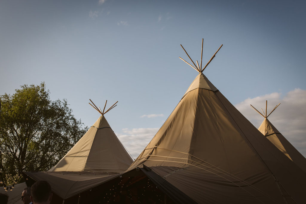 Outdoor festival style wedding in a tipi