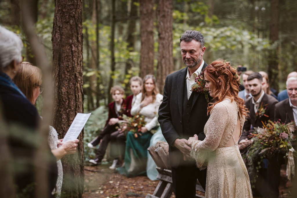 An outdoor wedding ceremony in the woods at Camp Katur