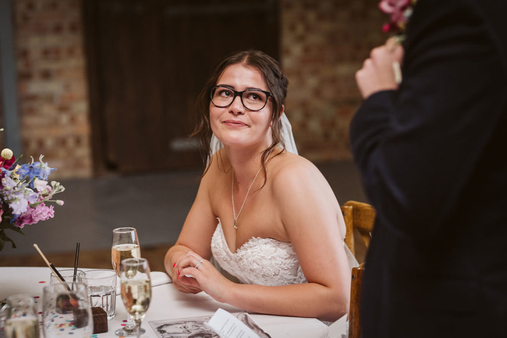 The Bride looking emotional during the Groom's speech