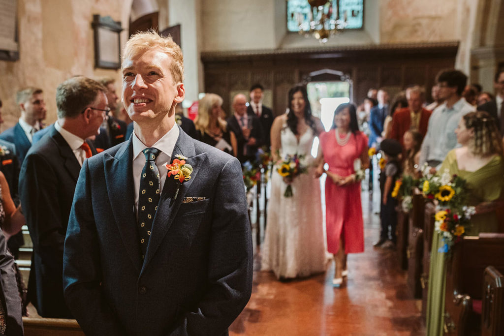 An excited groom awaits his bride to be!