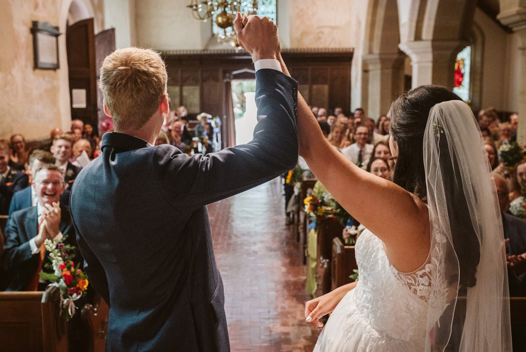 The bride and groom celebrating during their wedding ceremony