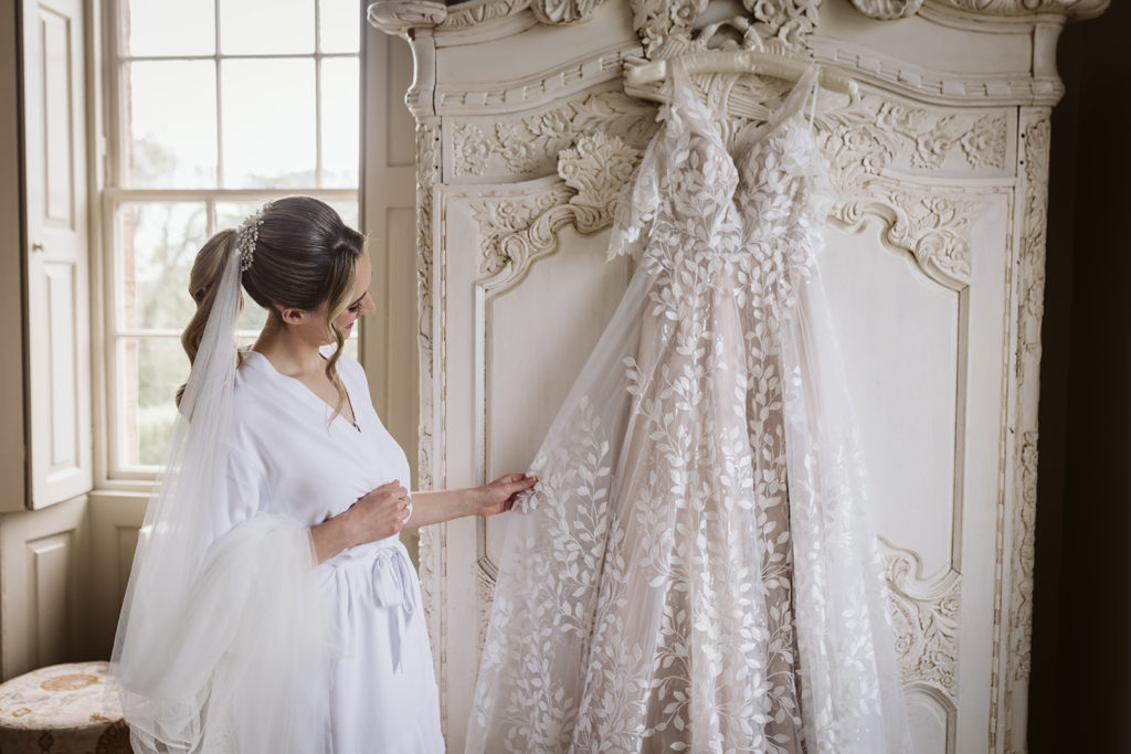 A bride during her wedding morning prep at Newton Hall