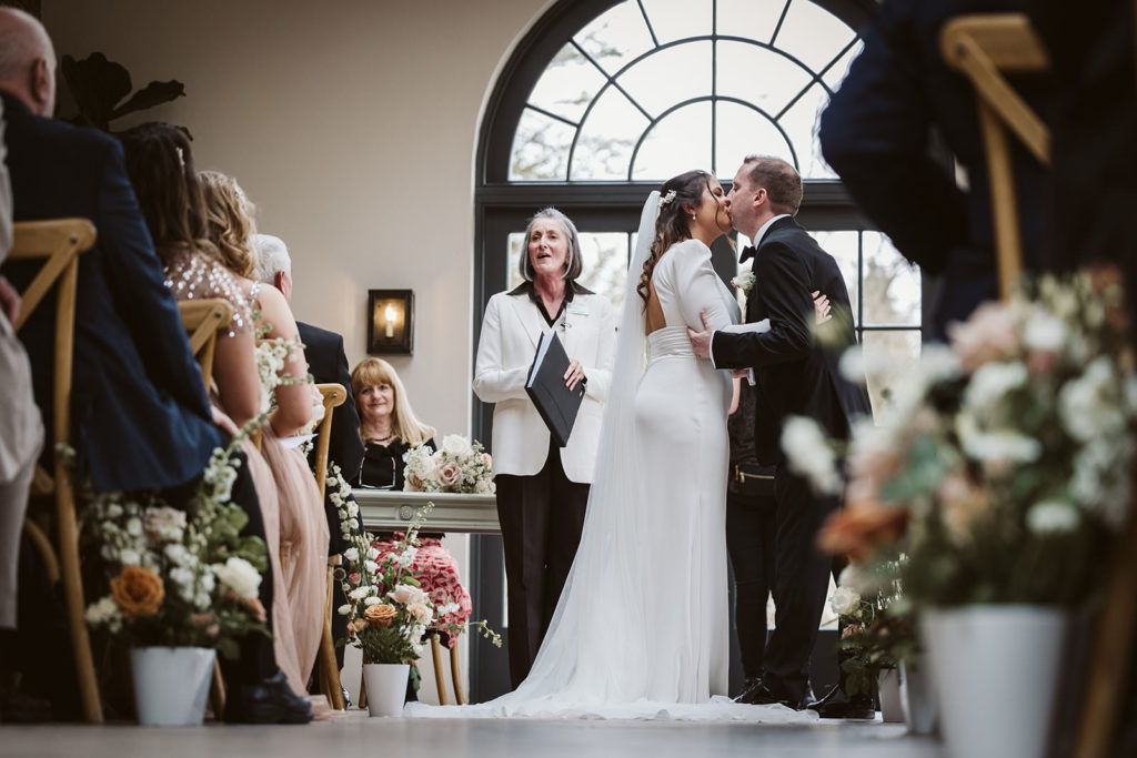 First kiss from the back of the wedding ceremony at the Fig House, Middleton Lodge.