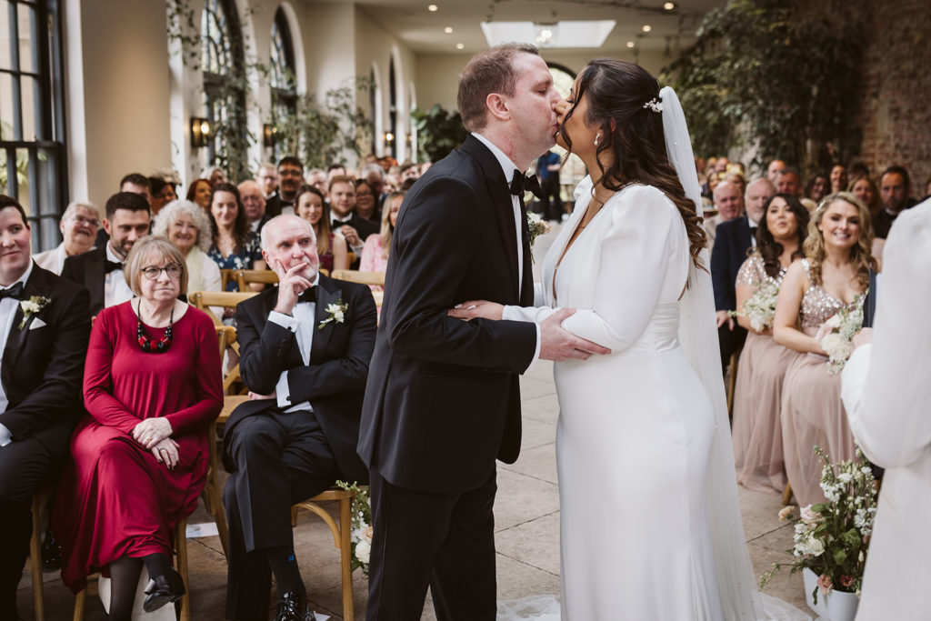 First kiss from the front of the wedding ceremony at the Fig House, Middleton Lodge.