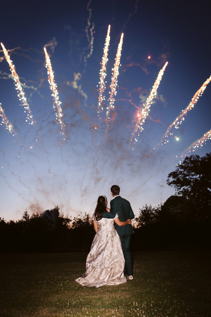 Bride & Groom watching fireworks display at their wedding