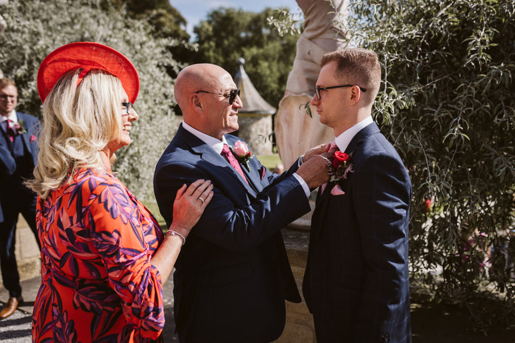 The Groom's parents readying him for his ceremony