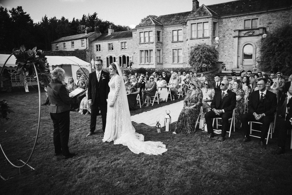 A black and white shot of the ceremony at the Saddle Room