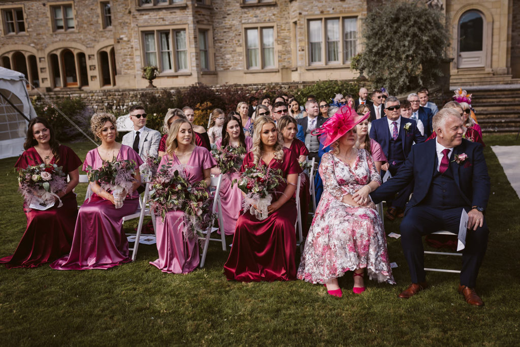 The Bride's parents and bridesmaids look on