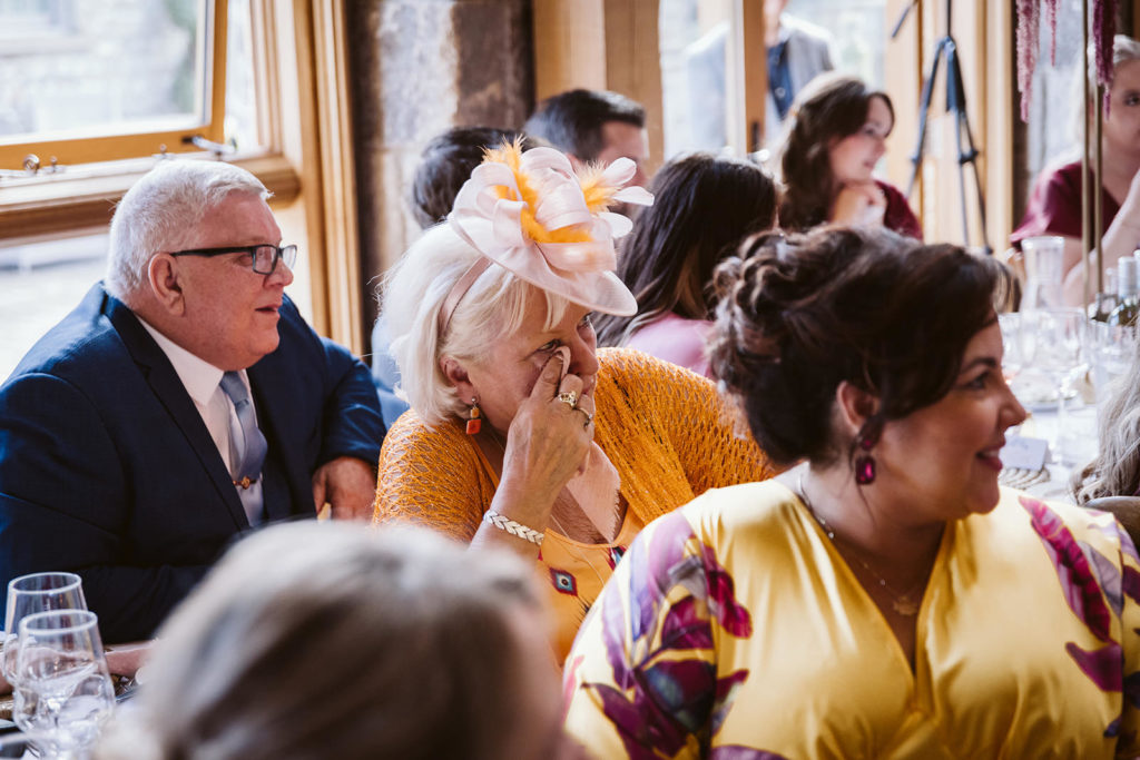 An emotional guest listens to the speeches