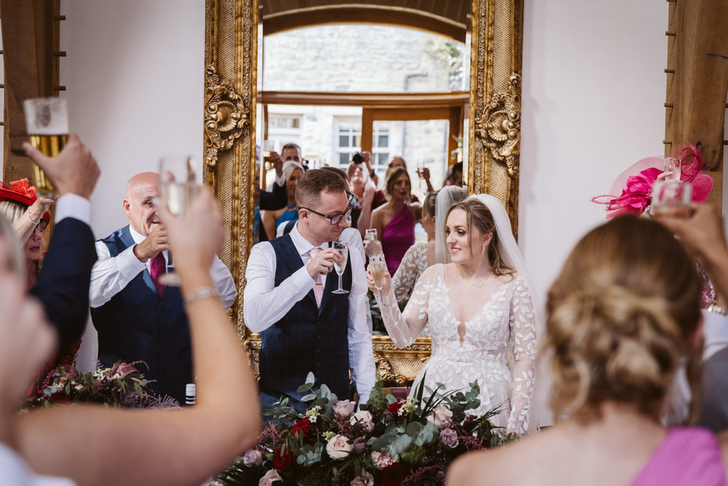 The bride and groom toast each other