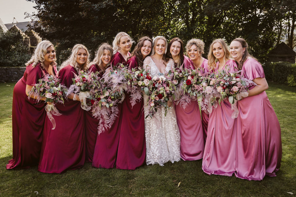 The Bride and her 9 bridesmaids sharing a pre-ceremony moment