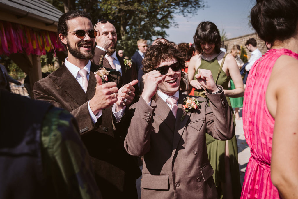 The groomsmen cheering for the happy couple