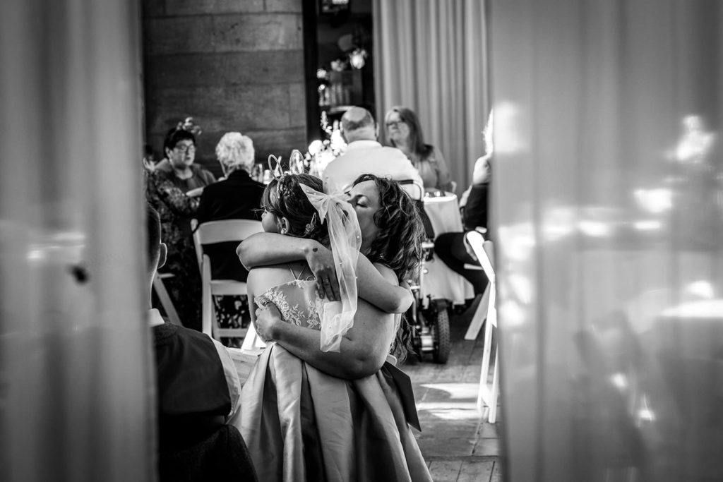 A tender moment between bridesmaid and flower girl