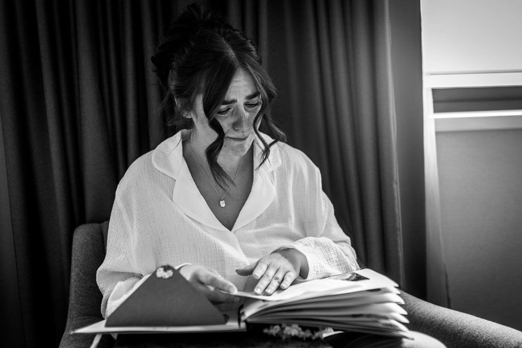 Emotional bride as she reads letters from her loved ones on her wedding morning.