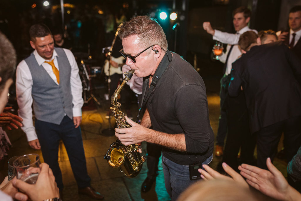 A saxophonist plays a solo with his wedding band
