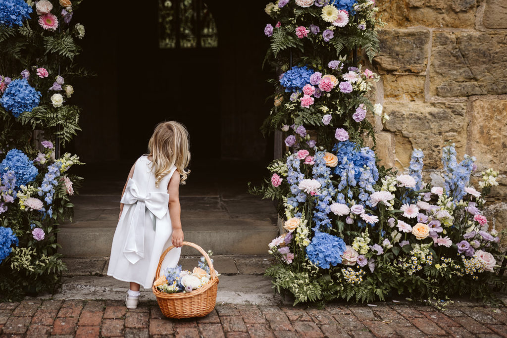 A little flower girl outside the church