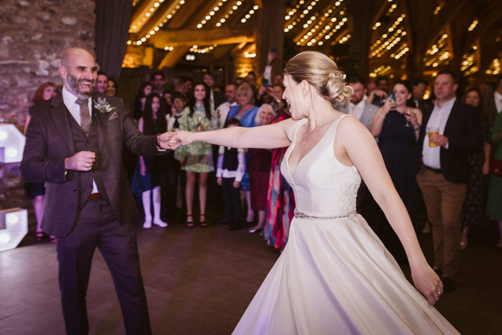 Dancefloor chaos at barn wedding with confetti and guests celebrating