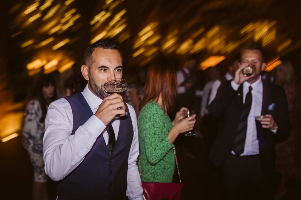 Guests mingling on the dance floor of  Tithe Barn