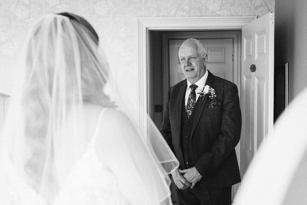 The father of the bride greats his daughter