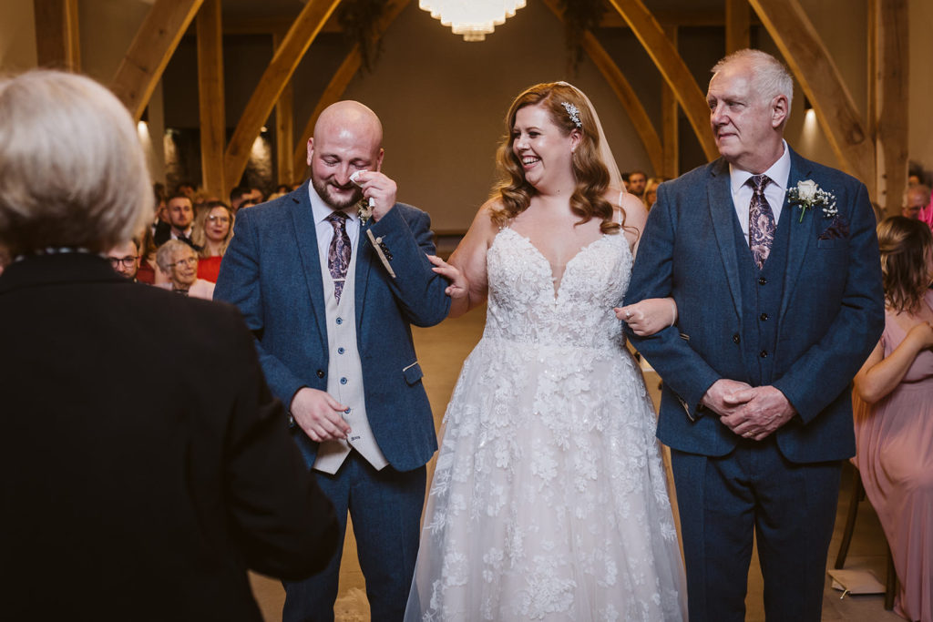 The Groom reacts to his bride walking down the aisle