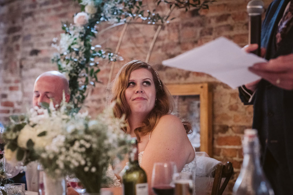 The bride listening to her father's speech