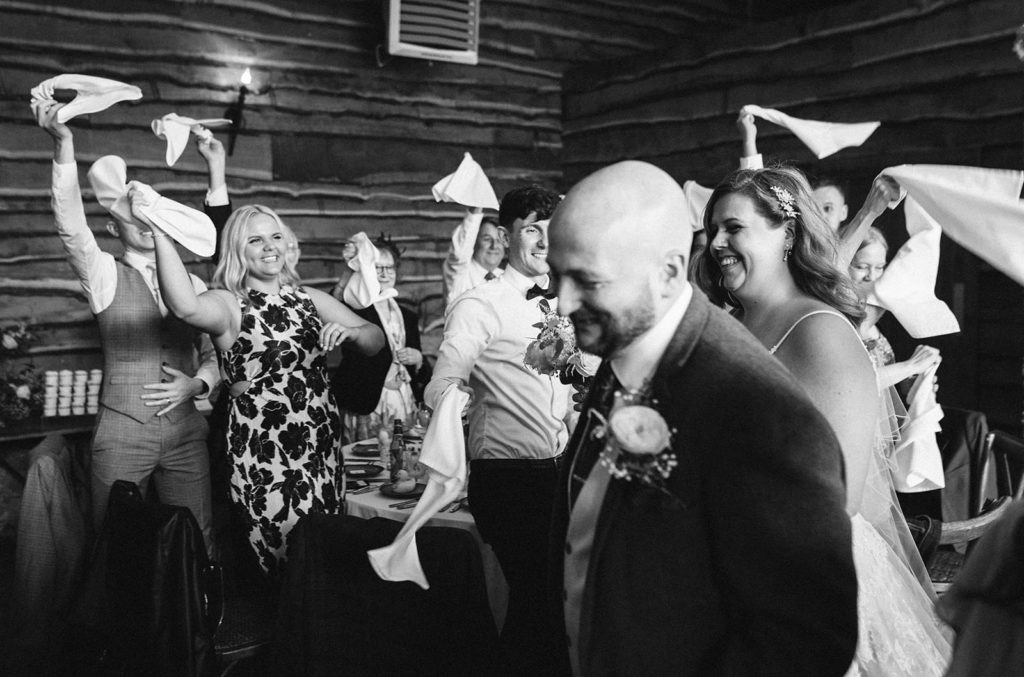 A big welcome for the happy couple as guests wave napkins