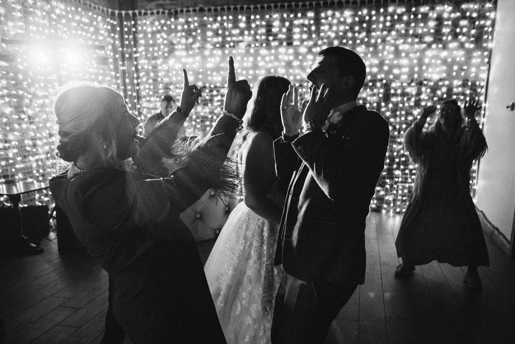 guests throwing shapes on busy Yorkshire wedding dancefloor