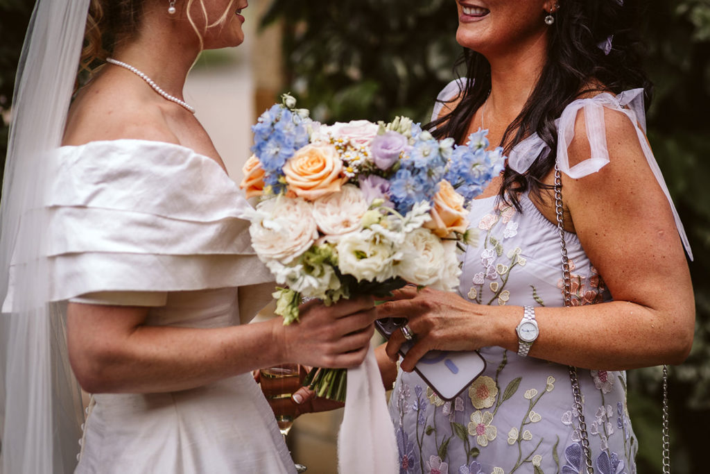 Relaxed outdoor wedding with second hand decor and guests mingling