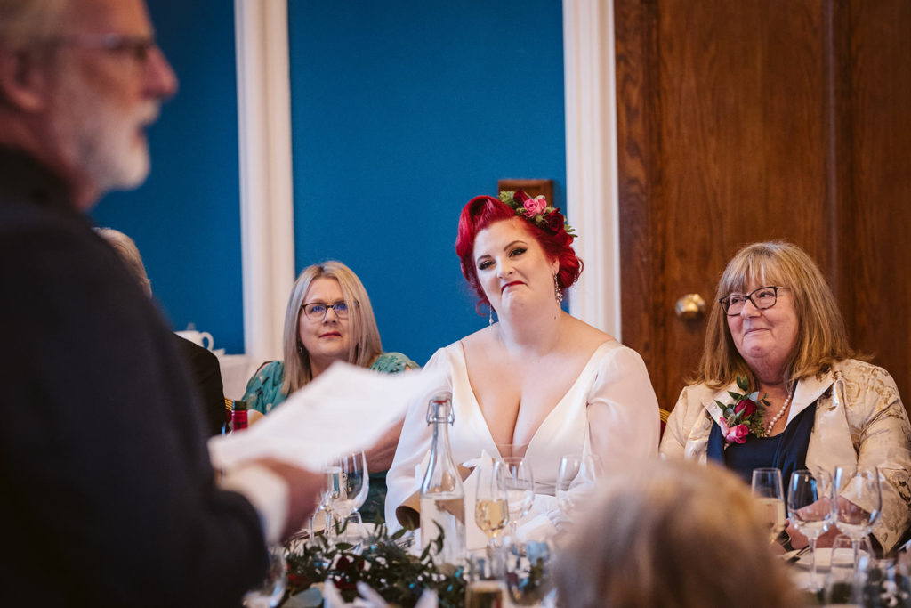 The Bride smiles proudly at her father as he makes his speech