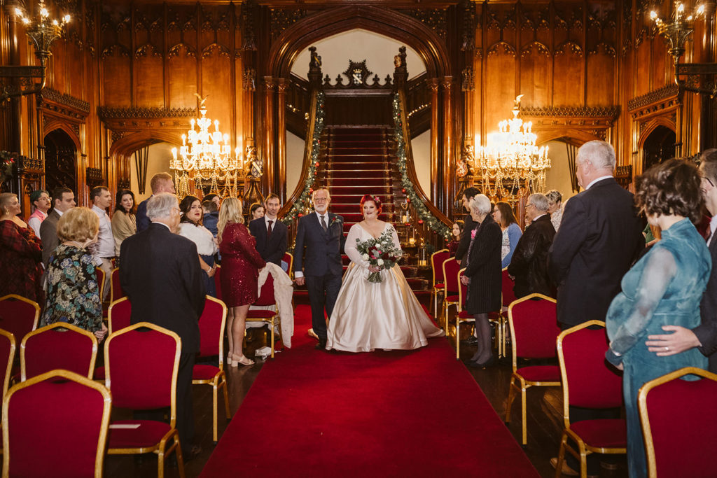 The Bride and her father make their entrance down Allerton Castle's dramatic staircase.