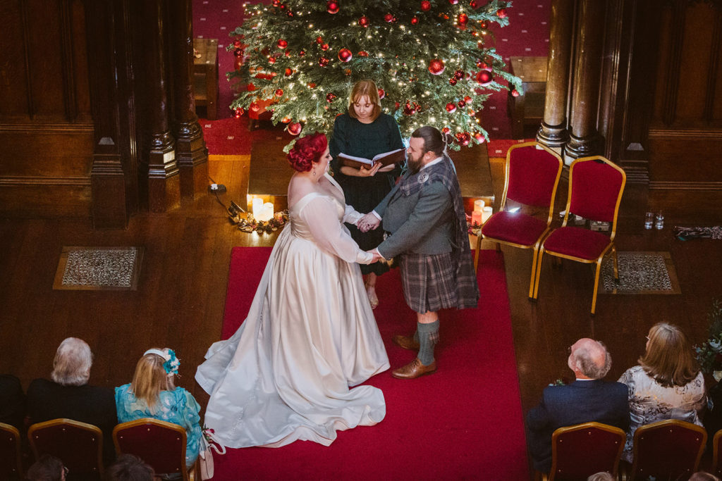 The Bride and Groom make their vows at this festive December wedding